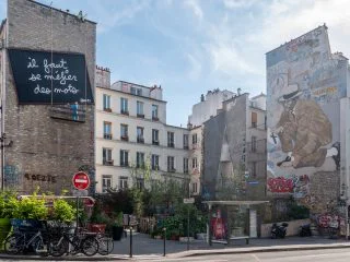 Paris, France - April 21, 2022: huge street art paintings on building facades at rue Belleville, Paris